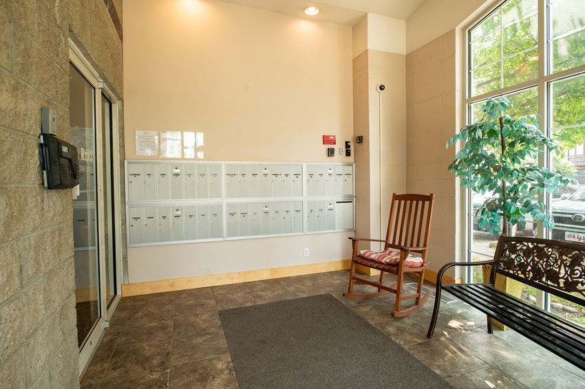 a bench and a rocking chair sit in front of a locker room with lockers on the - Photo Gallery