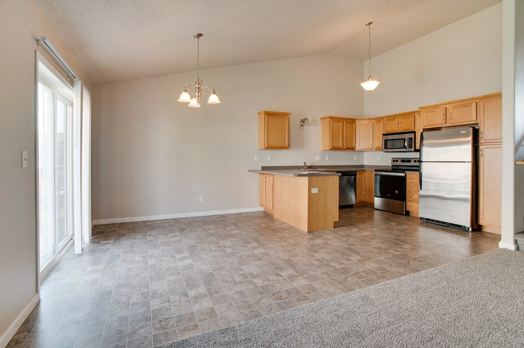 a kitchen and living room with a large window