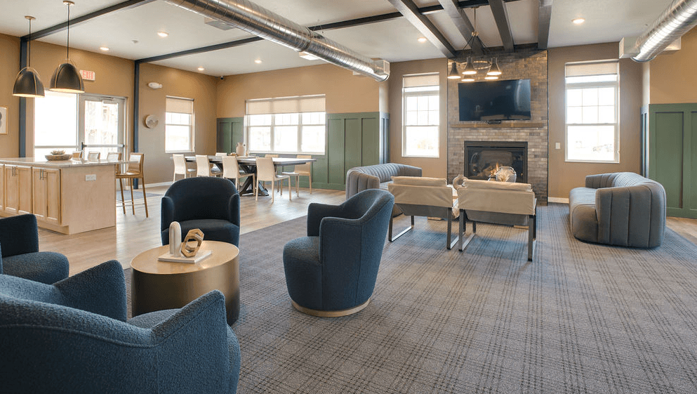 a living room with couches chairs and a fireplace and a kitchen, Pinehurst Apartments, Baxter, MN
