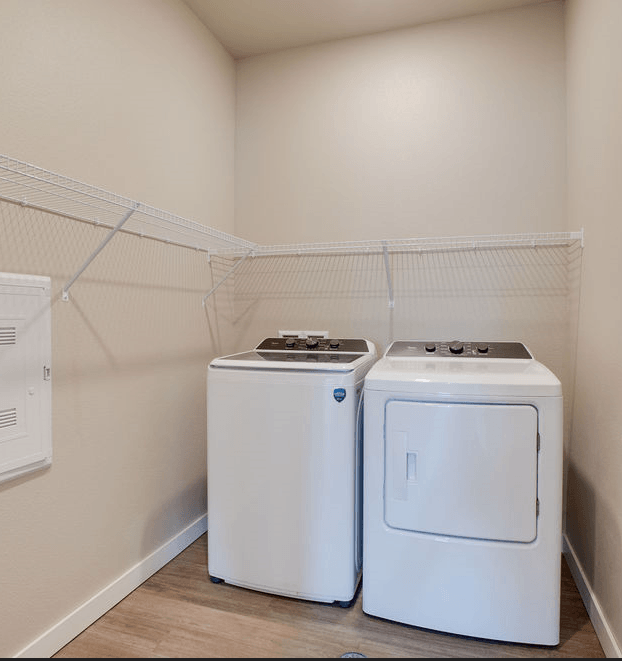 two washes and dryers in a laundry room with a rack on the wall, Pinehurst Apartments, Baxter, MN, 56425