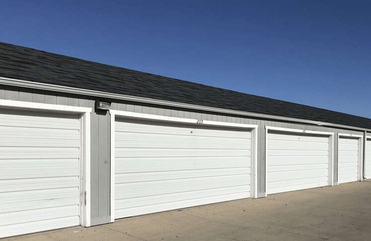 A row of white garage doors are closed at Royal Oaks Apartments, Fargo, ND, 58103