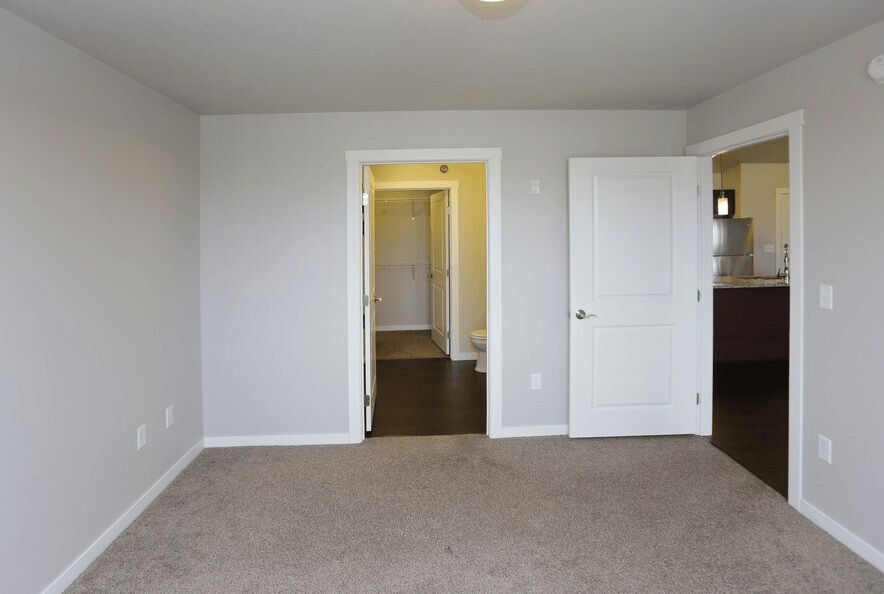 A room with a carpeted floor and white walls.