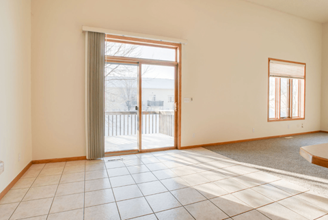 A room with a sliding glass door and a small window.