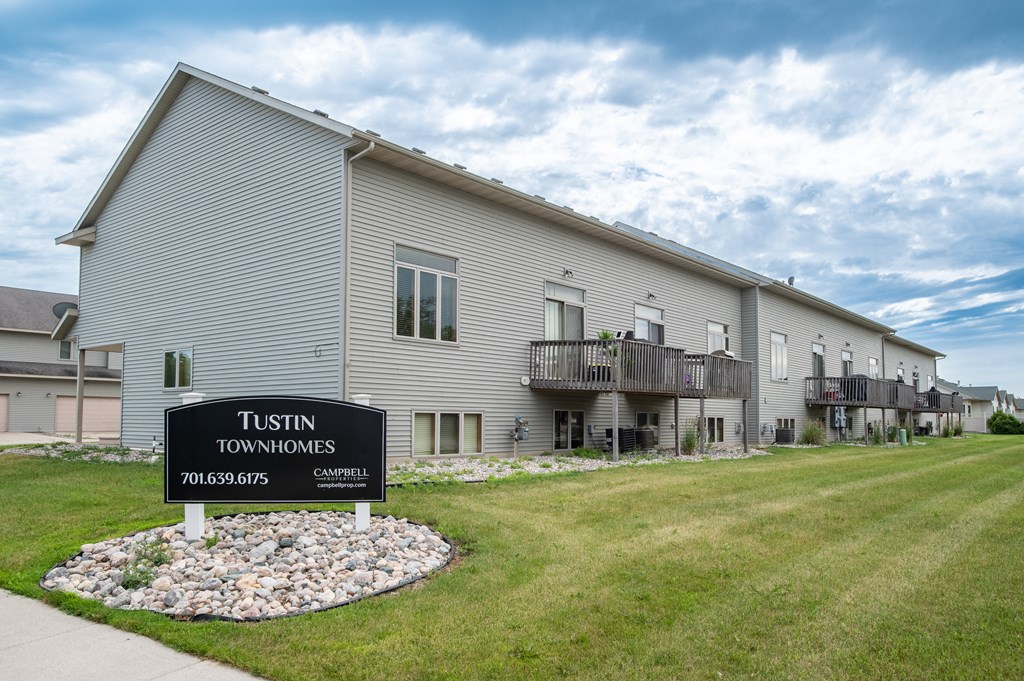 a building with a sign in front of it that says tulsa townhomes