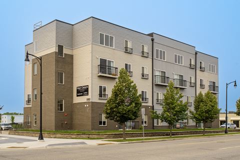 a large apartment building with trees in front of it