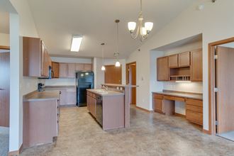 a kitchen with wooden cabinets and stainless steel appliances