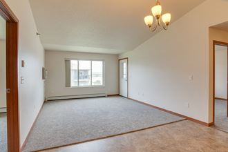 an empty living room with a window and a door - Photo Gallery 5