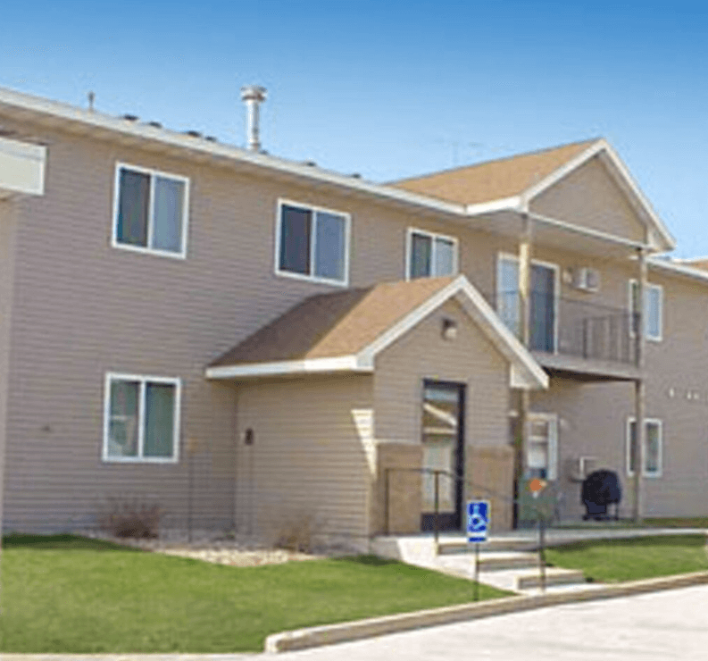 Apartment building with a blue handicap sign in front.