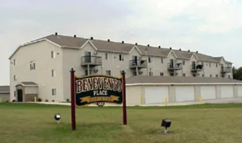 A sign that says Benevento Place in front of a building.