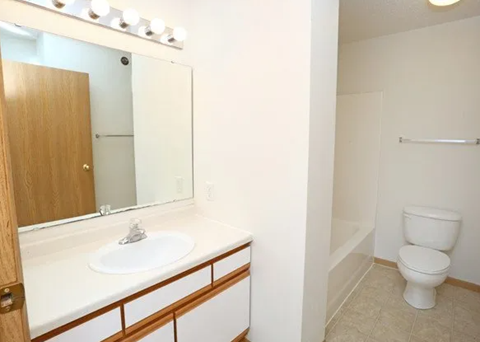 Bathroom with vanity and separate toilet area at Demaio Apartments, Fargo, North Dakota