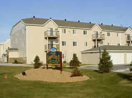 A large building with a sign in front of it.