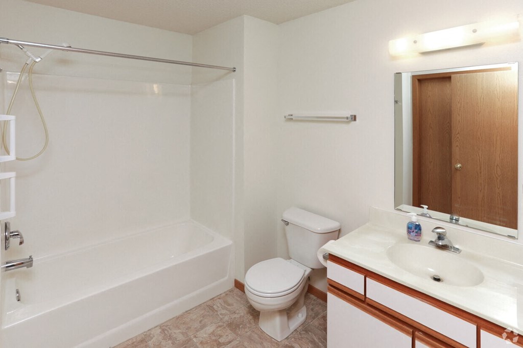 a bathroom with a toilet and a sink and a bath tub