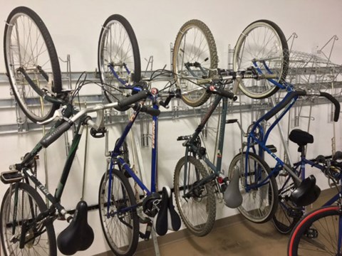a row of bikes parked on racks in a store