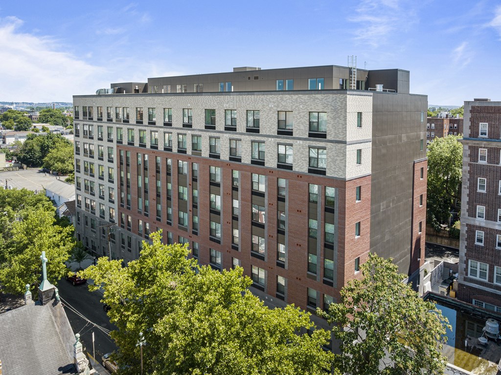 an aerial view of a tall brick building with trees