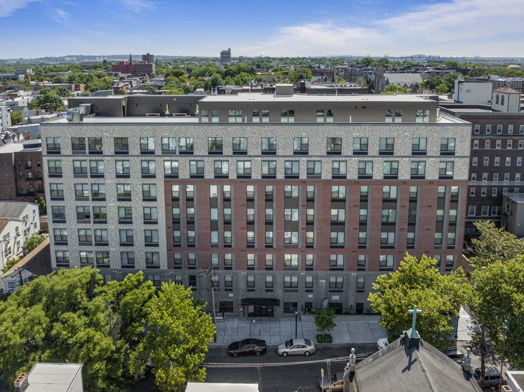 an aerial view of a large building with trees in front of it