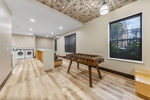 a game room with a foosball table and a large window