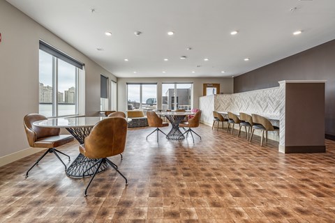 a conference room with a table and chairs and a large window