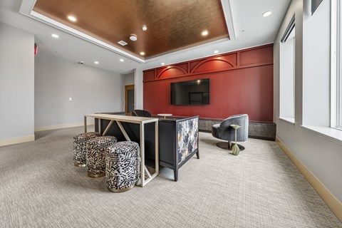 a conference room with a desk and a television in the corner