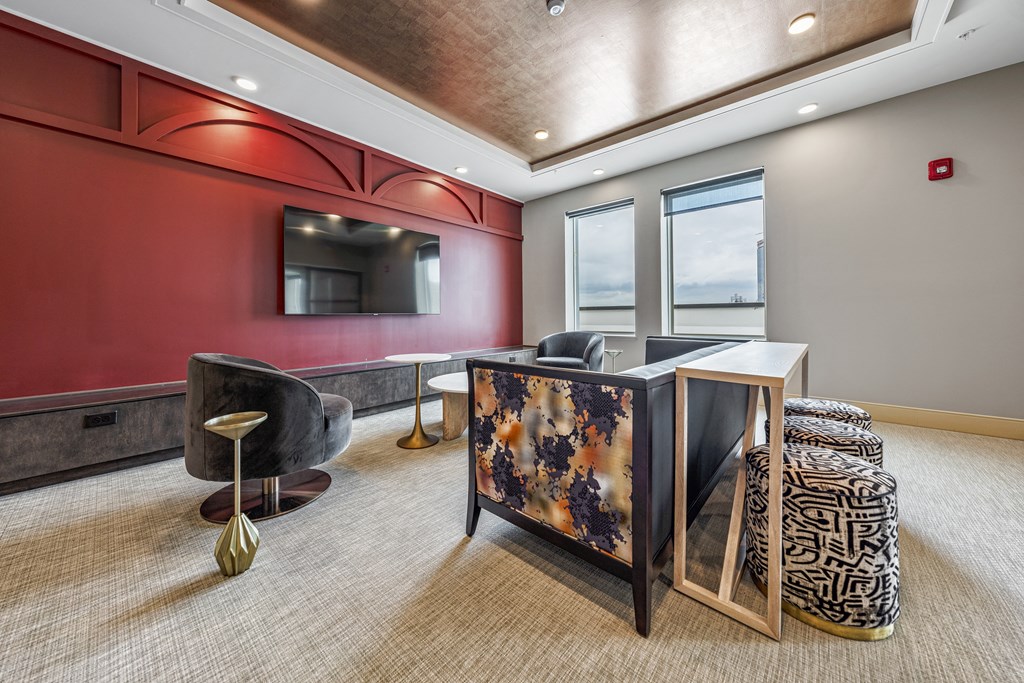 a lobby with a reception desk and a tv on the wall