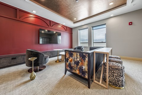 a lobby with a reception desk and a tv on the wall