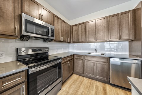 a kitchen with stainless steel appliances and wooden cabinets