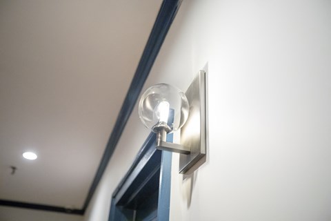 A wall light is mounted on a white wall.