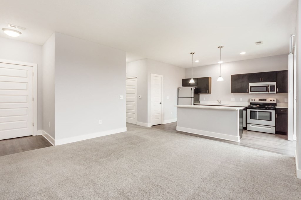 A spacious kitchen with a white countertop and modern appliances.