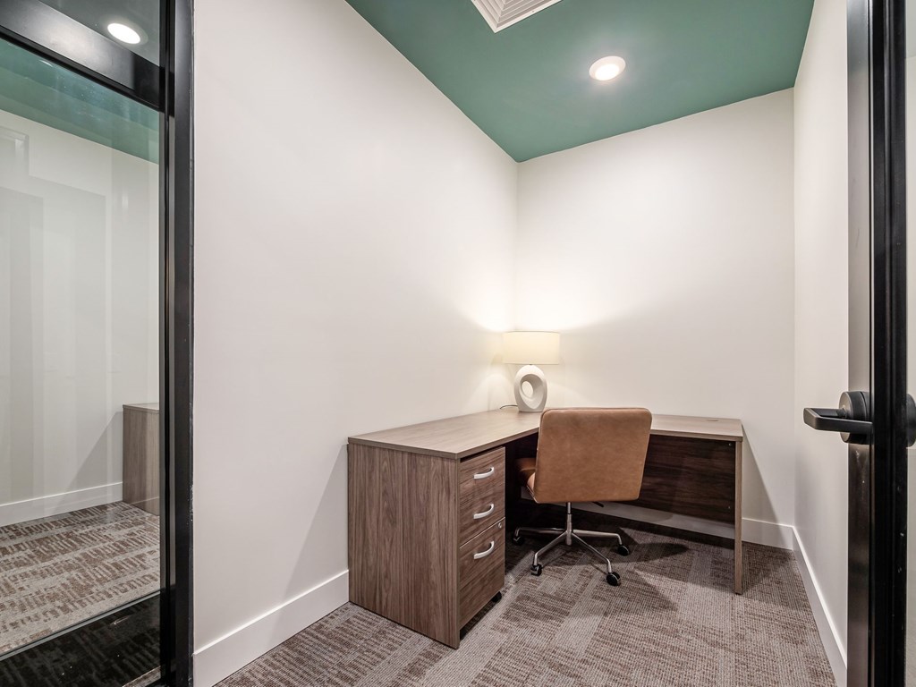 A room with a desk and a chair.