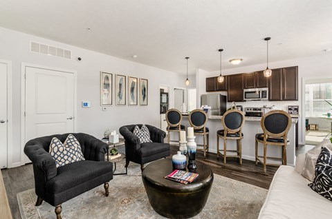 A living room with a black couch and a coffee table.