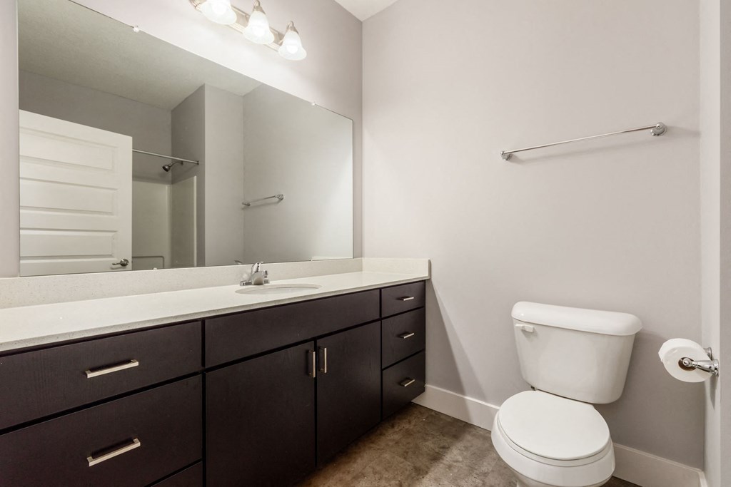 A white toilet sits next to a sink in a bathroom.
