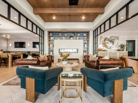 A living room with two blue chairs and a coffee table.