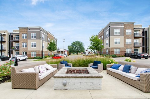 A sunny day at a residential area with apartment buildings and outdoor furniture.