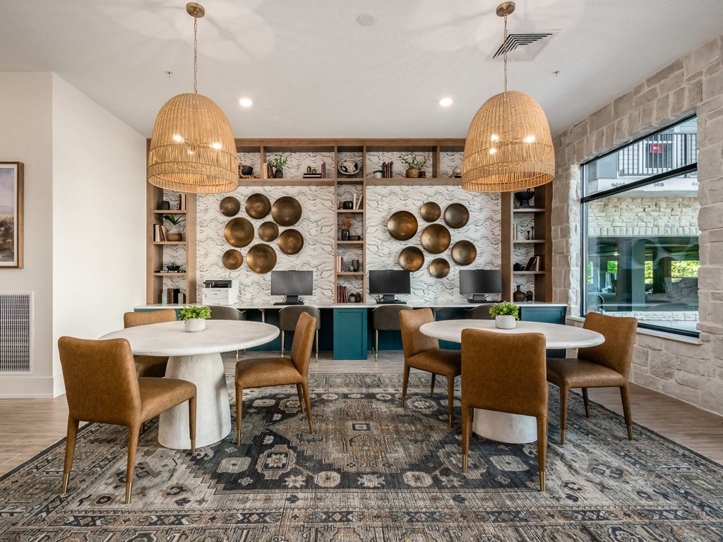 A dining room with a white table and chairs.
