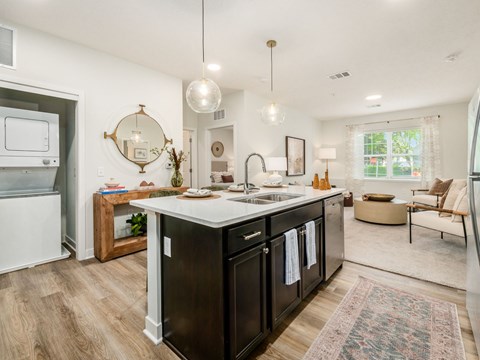 A modern kitchen with dark wood cabinets and a white countertop.