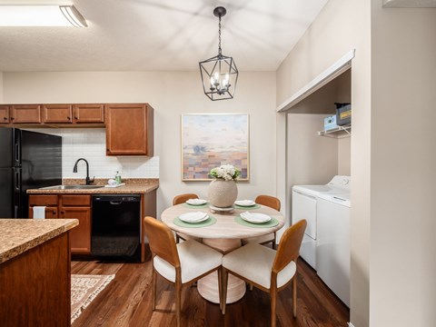 A kitchen with a dining table set for four.