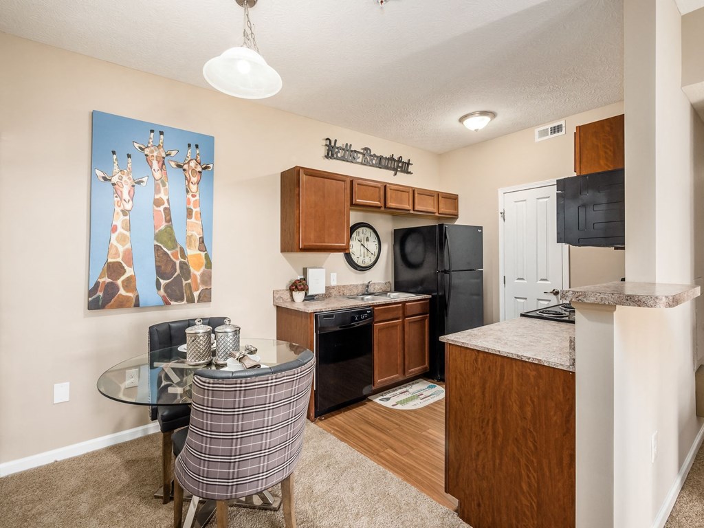 an open kitchen and dining room with a glass table and chairs