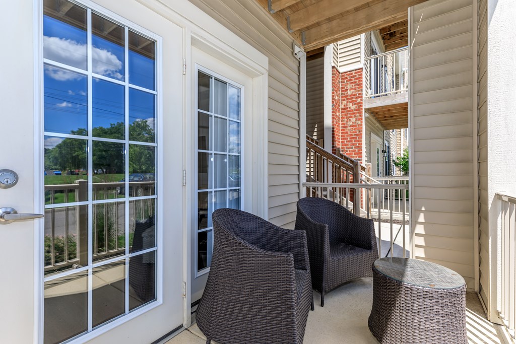 A patio with a chair and a table.