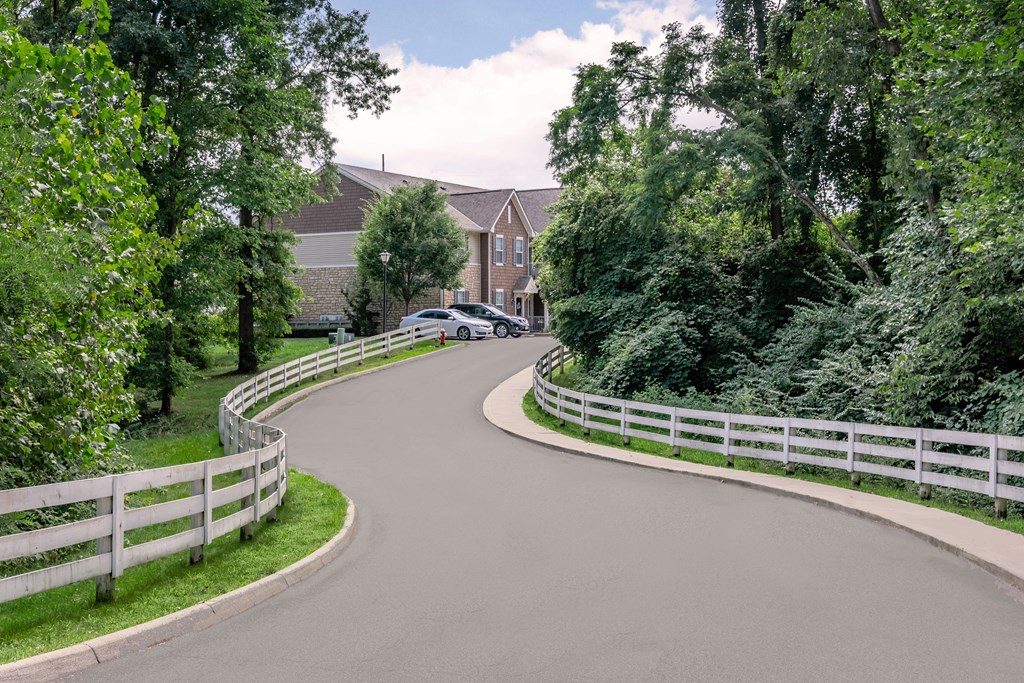 A car is parked on the side of a curvy road.