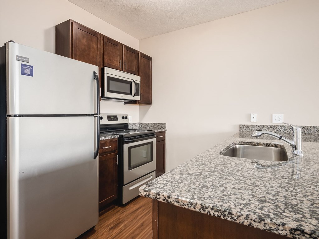 a kitchen with granite counter tops and stainless steel appliances