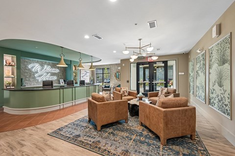 A reception area with a green wall and a sign that says "Welcome".