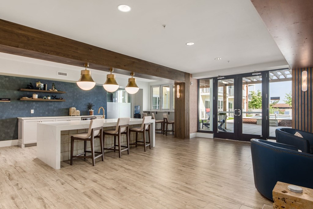 a kitchen and dining room with a white counter and chairs