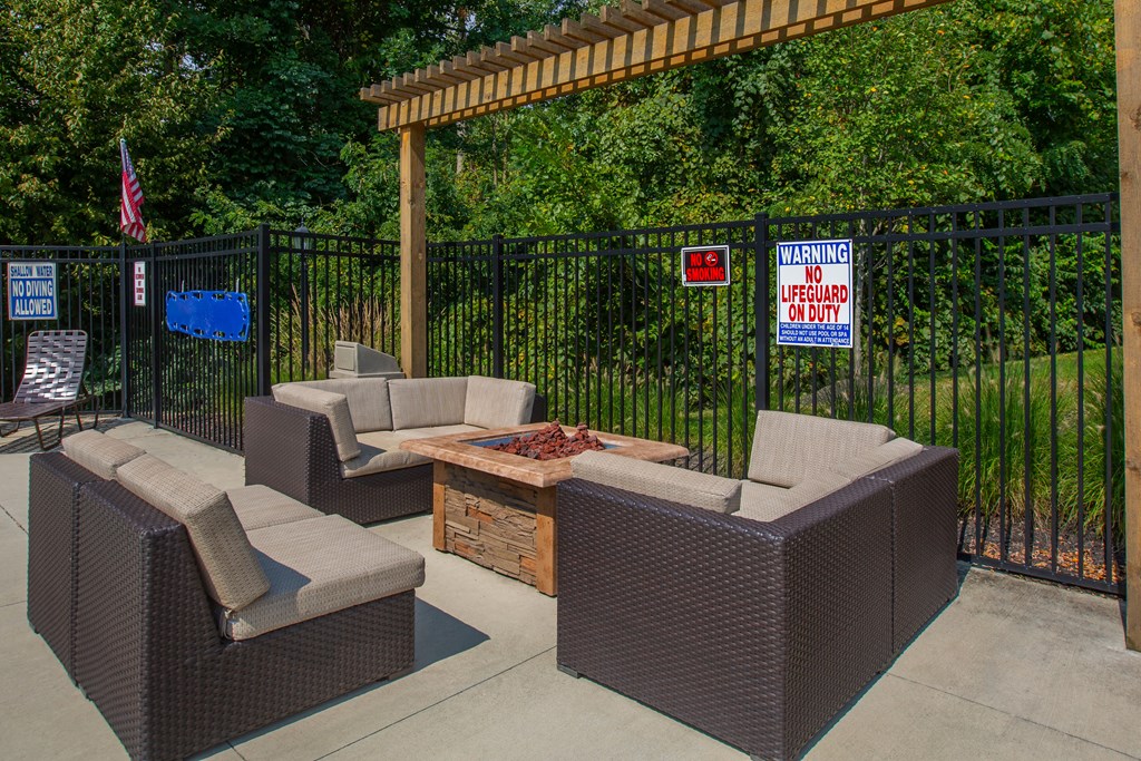 A patio with a black fence and a warning sign.