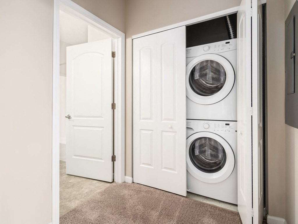 a front loading washer and dryer in a closet