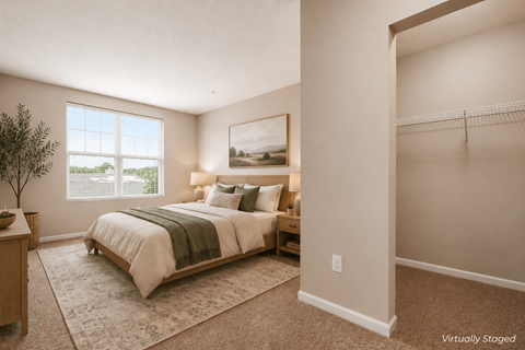 A bedroom with a large bed and a painting on the wall.