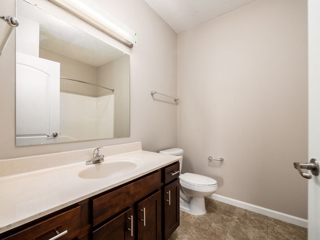 a bathroom with a sink toilet and mirror