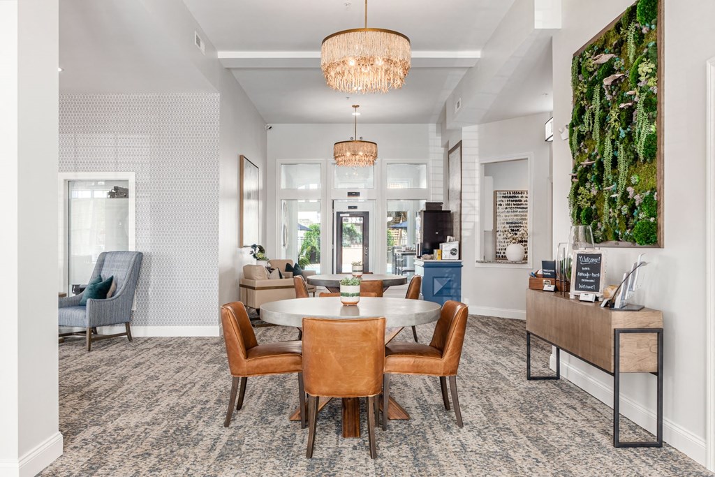 a dining room with a round table and chairs