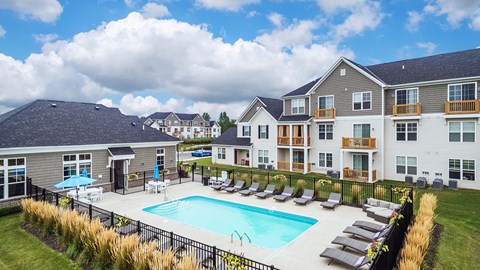 A large building with a pool in front.