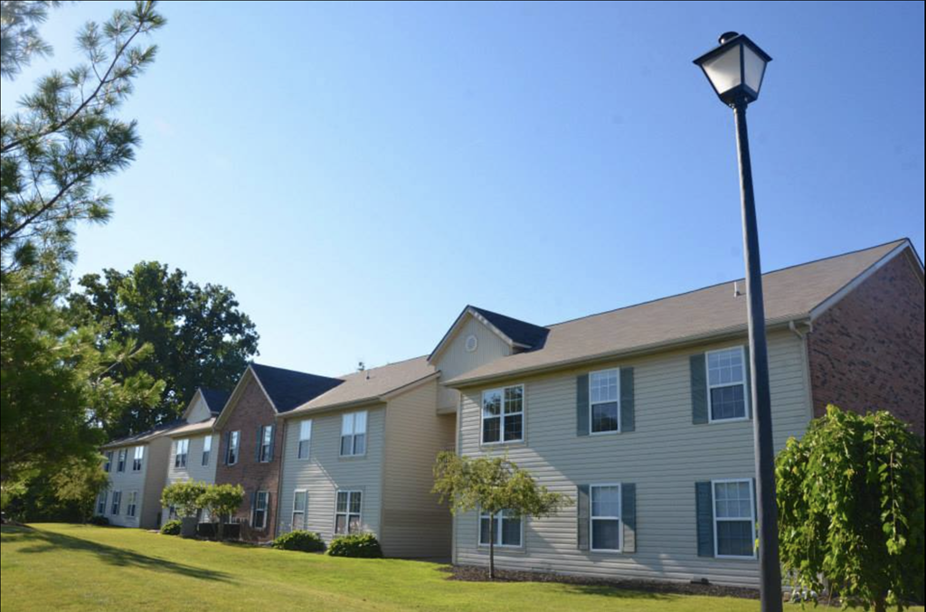an apartment building with a lamp post in front of it