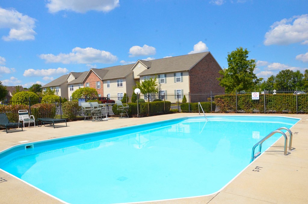 our apartments offer a swimming pool with a building in the background