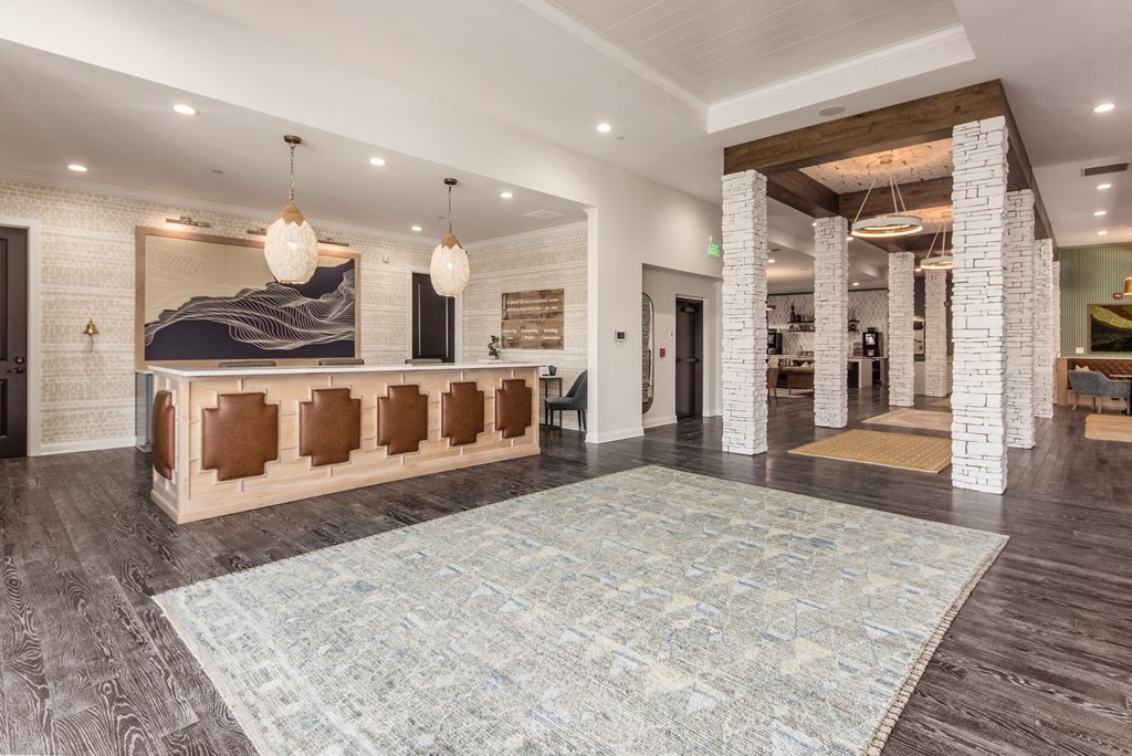 a lobby with a reception desk and a rug